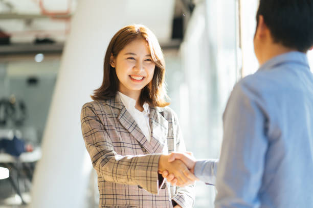 Adviser welcoming a client with a handshake